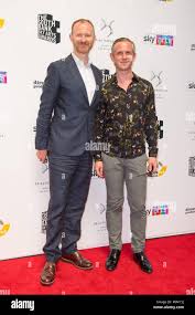 Mark Gatiss (left) and his husband Ian Hallard arriving for the South Bank  Sky Arts Awards at Savoy Hotel, central London Stock Photo