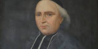 Bishop behind character in Les Misérables