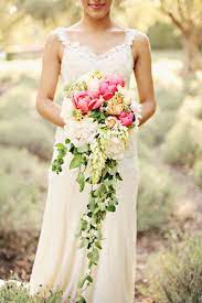 The floral arrangement is beautiful, regal, and makes quite the statement as you walk down the aisle on your wedding day. Wedding Bouquet Ideas Cascading Wedding Bouquets Spring Wedding Bouquets Cascading Bridal Bouquets