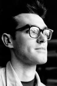 Frank Sinatra relaxes at home, watching television with a friend. Frank  wasn't photographed with glasses that often, although he wore them since  the 40's.