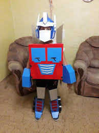 Cardboard boxes, paper rolls, hot glue, acrylic paint, spraypaint, velcro. Great Transformable Optimus Prime Wearable Costume For Kids Digital Diy Blueprints Great Diy Costumes