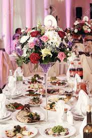 Consider matching the personalized table numbers to your wedding theme and or wedding colors for a cohesive look! Flowers In Vases And Numbers Of Setting At Wedding Tables With Stock Photo Picture And Royalty Free Image Image 77683450