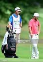 Kevin Chappell and his caddie, Brian Vranesh, look over the ...
