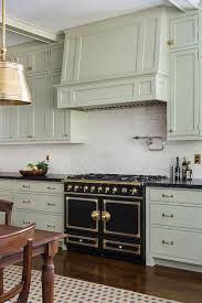 Beautiful Kitchen Boasts Light Gray Green Cabinets Paired With Black Granite Countertops And Cream G Green Kitchen Cabinets Light Green Kitchen Country Kitchen