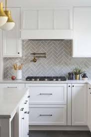 A farmhouse sink stands under two windows dressed in a gray print roman shade illuminated by a jamie young st charles mercury glass pendant. 13 Elegant Grey Kitchen Backsplash Ideas Inspiration Lmolnar Gray Kitchen Backsplash Kitchen Backsplash Designs Kitchen Trends