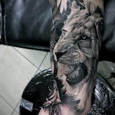 The lion is also a symbol of security which we can see in this tattoo where the lion is guided by the guardian angel. Outstanding Lion Tattoos Designs Segerios Com