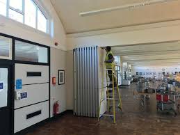 A 2″ x 6″ x 10′ was attached to the top of the wall with lag bolts that were counter sunk through the board into. Acoustic Movable Walls Folding Partition Movable Room Divider