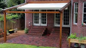 Wood Framed Monza Model Retractable Water Proof Exterior Pergola Retractable Awning Shown In The Partially Extended Position Patio Pergola Retractable Awning