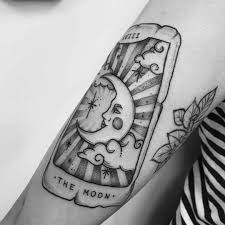 The word sisters is written on the side in cursive. 25 Magical Tarot Card Tattoo Examples
