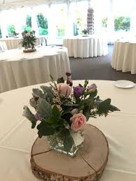 Wedding Table Floral Arrangement On A Wooden Log Base Table Floral Arrangements Flower Arrangements Floral Arrangements