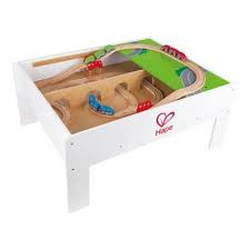 A table is an item of furniture with a flat top and one or more legs, used as a surface for working at, eating from or on which to place things. Hape Railway Play And Stow Wooden Train Set Activity Toy Storage Play Table Target