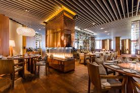 ritz resto contemporary dining room with high ceilings a variety of tables and a glass enclosed fir fine dining restaurant luxury restaurant restaurant design