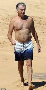 Pierce bronsan is a charismatic actor known primarily for his amazing portrayal of james bond. Pierce Brosnan 66 And Wife Keely Shaye Smith Frolic On Hawaiian Beach In Swimsuits Daily Mail Online