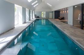 If you have some privacy or a great view, large glass panes can be a focal point for your indoor pool area. Indoor Swimming Pool Servicing Showcase Lspc