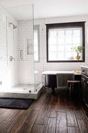 Wooden floorboards are painted white to match the rest of the scheme, but the montage of green the whole corner of this bathroom has been dedicated for a really spacious shower with dark wood floor, closed behind clear glass doors. Wood Tiles Bathrooms Remodel Bathroom Inspiration Bathroom Design