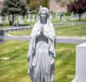 Granite stone Virgin Mary statue on the top of a headstone ...