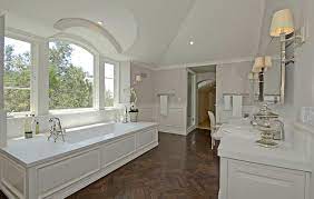 Here, herringbone floors smoothly transition from the kitchen to the sitting room and through the hallway. Wood Herringbone Floor Transitional Bathroom