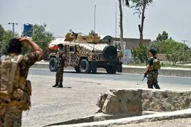 An afghan national army soldier surveying atop a humvee; Afghan Forces Struggle Against Taliban Assaults On Major Cities