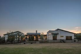 The front porch features include stamped and stained concrete, yellow pine tongue and groove ceiling, cedar posts, a 42 wide by 8' tall alder door with flemish glass,and limestone veneered walls. Hill Country Modern Vanguard Studio Architect Austin Texas