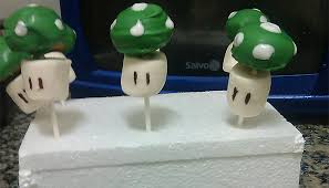 Super mario cake pops stars, bombs, and mushrooms. Cake Pops Mario Bros 1 Up Dulces Geek