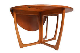 The open bottom shelf provides an interesting visual while providing useful storage space. Round Drop Leaf Dining Table By Beithcraft For Sale At 1stdibs