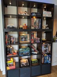 Our Board Game Display Two Ikea Kallax One 4x4 With Bins And One 2x4 Units We Joined Them Together Anchored Them To The Kallax Ikea Kallax Board Game Room