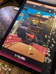 Image features a romantic photo of a couple sitting on a hammock at night. So Close Yet So Far 1000 Piece Spirited Away Puzzle I Bought In Japan Ghibli