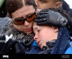 Kerry Flick consoles her son, Sage, during an anniversary ceremony  remembering the terrorist bombing that killed 270 people, at Arlington  National Cemetery