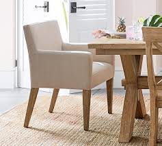 The alcott hill kosinski upholstered dining chairs are formal chairs with beautiful upholstered arms, and they would make a stunning addition to any formal dining space. Classic Upholstered Dining Armchair Pottery Barn