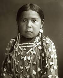 Riders fording a river with a crow in early 1900s