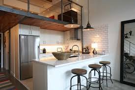 The sleek lines and smooth surfaces of matte fenix kitchen cabinets help define not just the kitchen area but this entire modern loft. 22 Beautiful Kitchen Design For Loft Apartment Loft Apartment Kitchen Loft Kitchen Industrial Kitchen Design