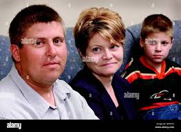 Chad Combs, left, is flanked by Sheri Holcomb, center, a Rock County  Christian School kindergarten teacher and his son Matthew, 7, in  Janesville, Wis., Oct. 21, 2003. Combs will soon be getting