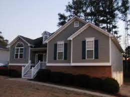They add definition and a touch of elegance. Like The Grey Siding With Black Shutters Off White Trim And Red Brick Red Brick House Grey Siding House Paint Exterior
