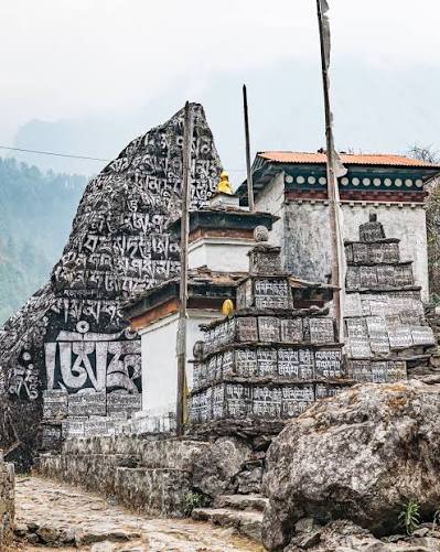 Did you notice the Mani stones? Mani stone walls along the trail from Lukla  to Namche Bazaar are sacred spiritual and cultural landmarks frequently  seen on the Everest Base Camp (EBC) trek.