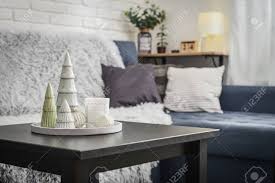 Your coffee table is the anchor of your living room, making a design statement and serving as a visual focal point. Christmas Decorations With Candle On Coffee Table In Living Room Near Couch Closeup Stock Photo Picture And Royalty Free Image Image 111494388