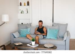 Be who you are and say what you feel, because those who mind don't matter, and those who matter don't mind. Happy Young Blonde Man Sitting Couch Stock Photo Edit Now 777690382