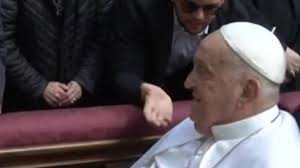 Many in the crowd reached out to touch Francis' hand or garments as he was  brought in a wheelchair down a ramp to the main alter.