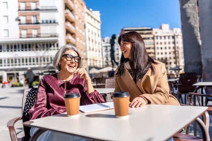 Two businesswomen discussing ideas over coffee