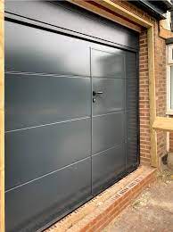 A Hormann Lpu42 L Ribbed Sectional Garage Door Wicket Door Finished In Anthracite Grey Sectional Garage Doors Garage Door Styles Garage Doors