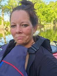 Kayak pinned against tree