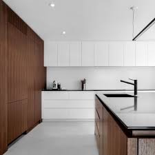 Second nature kitchens 'remo' doors in matt dove grey, with contrasting denver oak carcasses/framing panels with 20mm silestone finished off with a quooker boiling water tap. Minimalist Interior Design Dezeen
