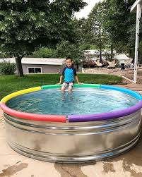 To Make Stock Tank Pools Safer And More Comfortable For Kids And Families Folks Are Using Pool Noodles To Li Stock Tank Pool Stock Tank Pool Diy Backyard Pool