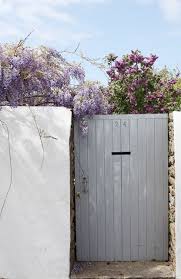 Love The Colors And Wisteria Creeping Over The Wall Garden Inspiration Garden Outdoor Landscaping