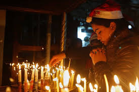 A Christian Worshipper Prays After Lighting A Candle On Christmas Eve At The Church Of The Nativity Built Atop The Site Where Christians Believe Jesus Christ Was Born Abc News Australian
