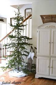 I Love The Framed Vintage Clock Faces On The Stairway And Of Course The Tree White Christmas Decor Charlie Brown Christmas Tree Christmas Decorations