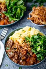 Yep, just confirmed we'll be making this meal on every rainy day from now until labor day. Stick To Your Ribs Comfort Food For A Cold Rainy Day This Slow Cooked Beef And Guinness Stew With Crispy Onions Is Perfe Cold Meals Beef Recipes Comfort Food