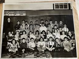 This photo is from 1949. It is our cousin Eddie McCarley's first grade  picture. We noticed what looks like our uncle Jimmy Holley in this picture.  Anyone know who the young lady/teacher