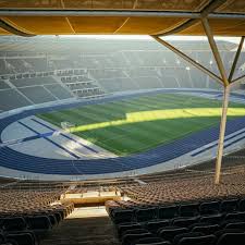 Summer olympics at a nearly empty soccer stadium, a subdued olympic atmosphere. Step Inside The Olympic Stadium Berlin Experiences