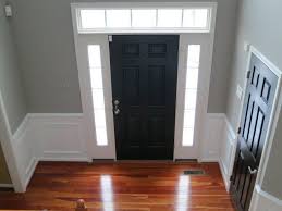 A black front door makes a striking statement. Door Tricorn Black By Sherwin Williams Walls Wood Smoke By Glidden Black Interior Doors Cherry Wood Floors Floor Colors