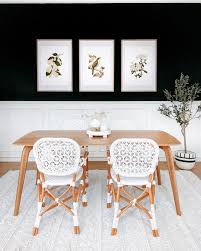Another wall contains a series of white trimmed mirrors, and the centerpiece of the design is a lovely light fixture hanging above the dining table. 29 Dining Room Wall Decor Ideas